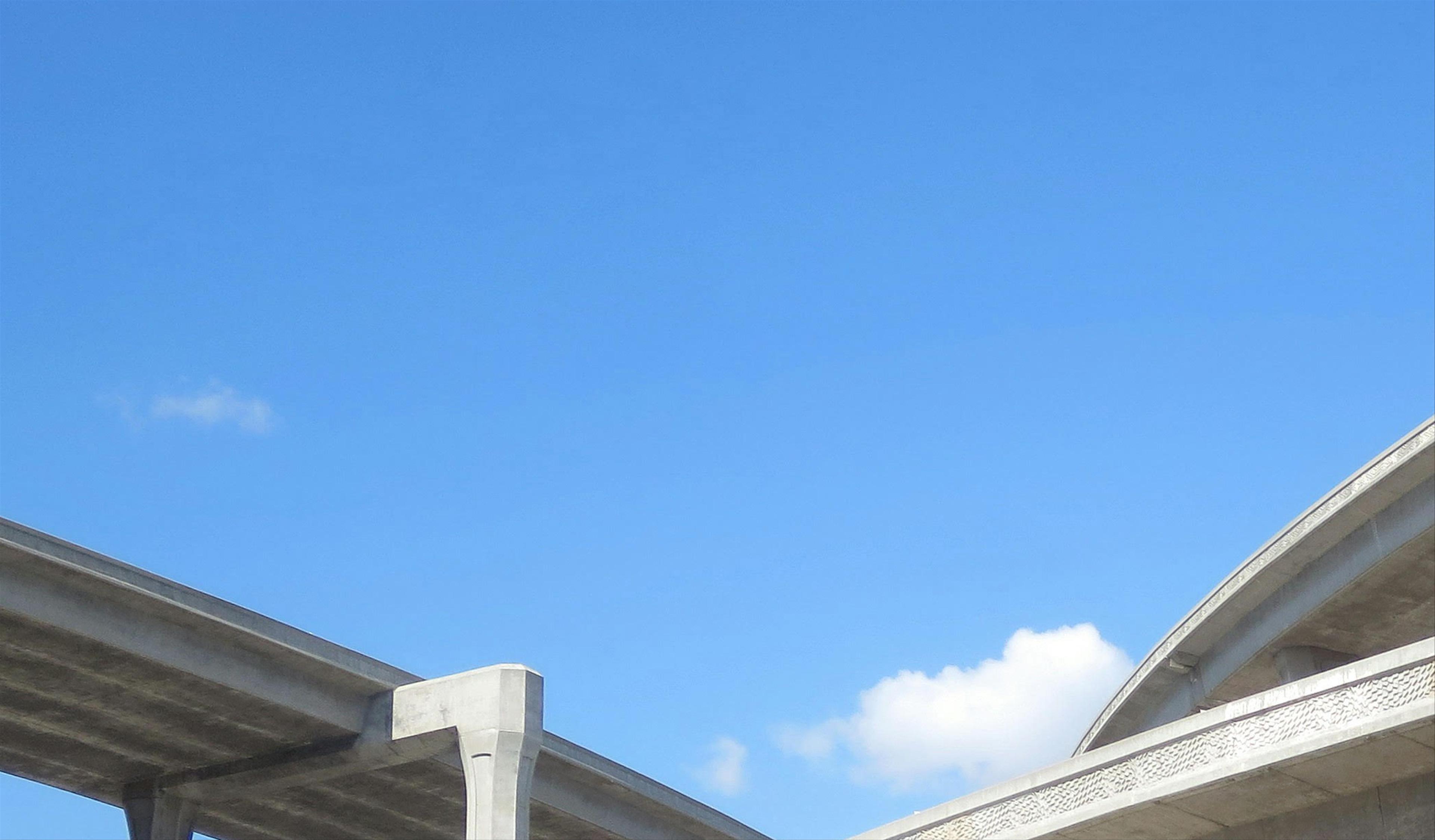 Clear sky overlooking a highway overpass.