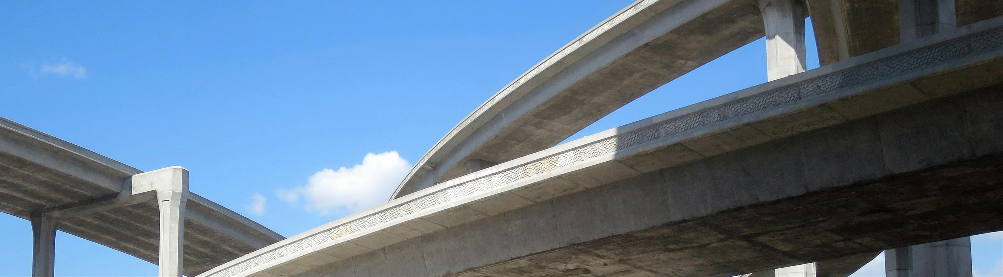 Traffic on a busy stretch driving under a camera system.